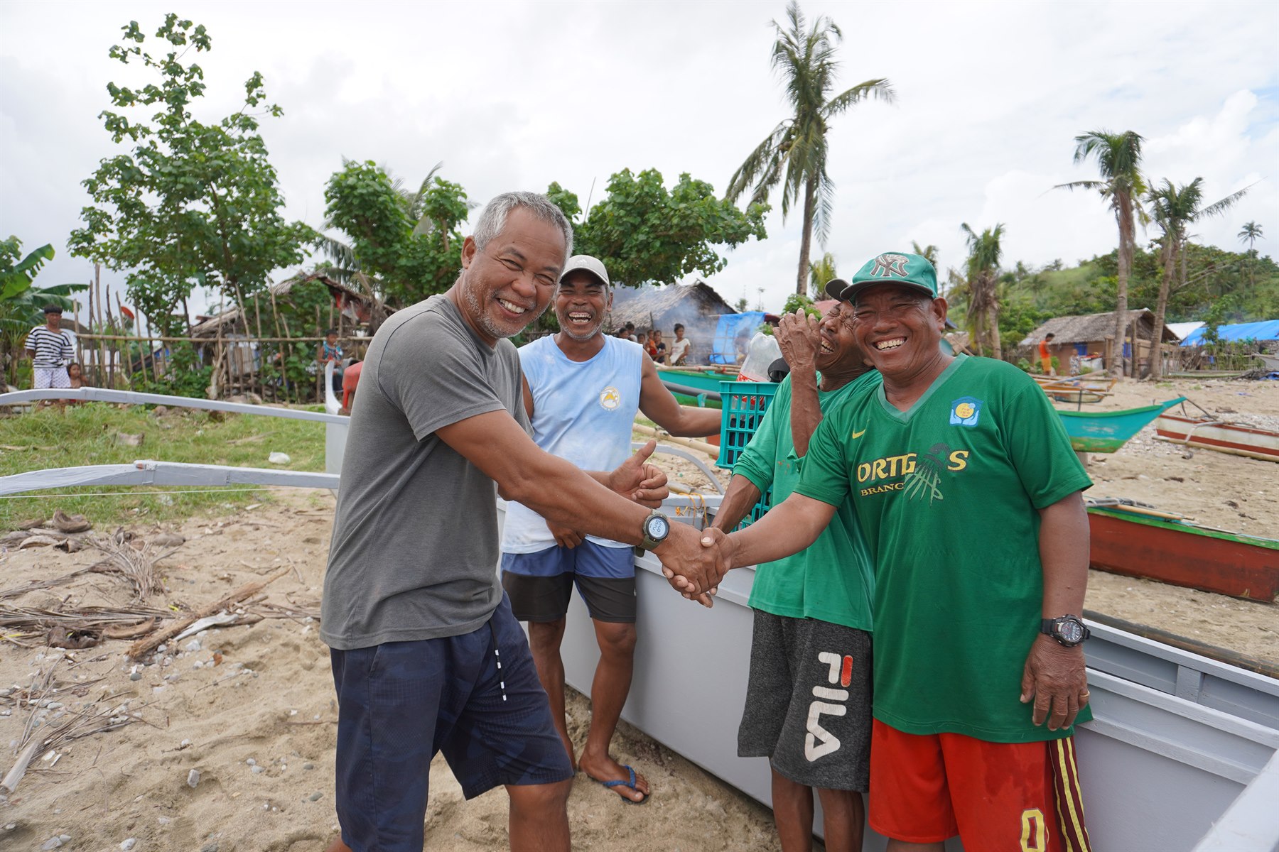 A Bantay Dagat member standing with a patrol boat